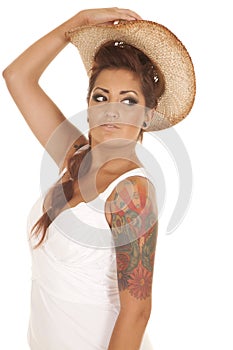 Woman tattoos cowgirl hat on