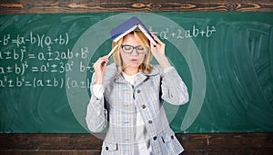 Woman teacher with book as roof on head. Memorizing method. Train memory every day. Effective method to remember