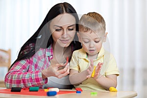 Woman teaches child handcraft