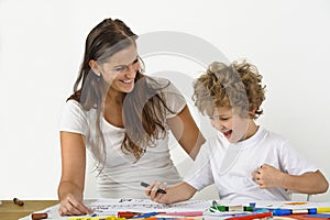 Woman teaches her child how to draw
