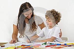Woman teaches her child how to draw photo