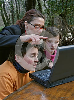 Woman teaching children at the laptop