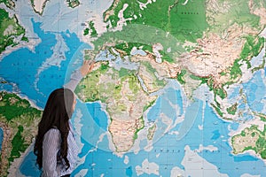 Woman teaching geography in world map photo