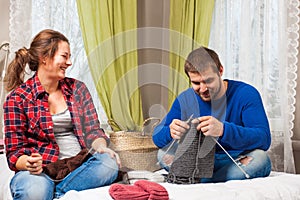 Woman is teaching knit a young man