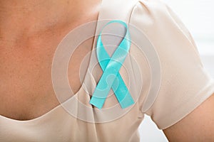 Woman With Teal Ribbon To Support Breast Cancer Cause
