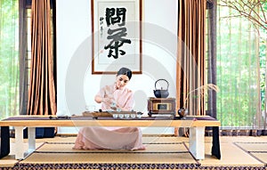 A woman with a teapot-China tea ceremony photo