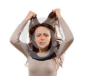 Woman tearing at her hair in desperation