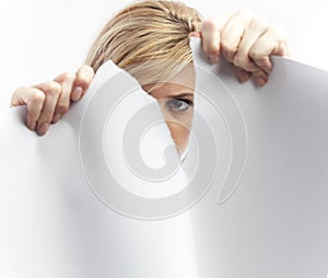 Woman tearing paper sheet