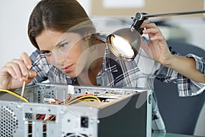 Woman technician fixing computer
