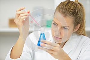 woman technician with multipipette in genetic laboratory pcr research