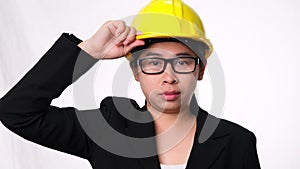 Woman technician smiling with helmet. Confident woman construction worker on white background in studio.
