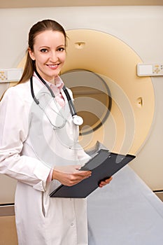 Woman Technologist with CT Scan Machine photo