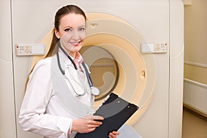 Woman Technologist with CT Scan Machine photo