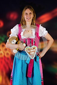 Woman with teddy and gingerbread at fun fair