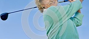 Woman teeing off with her driver golf club