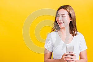 Woman teen smile standing playing game or writing message on smartphone