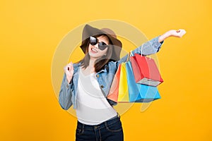 woman teen smiling standing with sunglasses excited holding shopping bags multi color