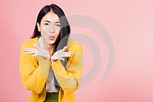 Woman teen standing blowing kiss air something on palm