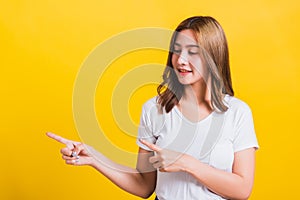 Woman teen standing wear t-shirt pointing finger away side