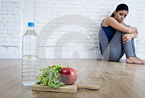 Woman or teenager girl sitting on ground alone worried at home
