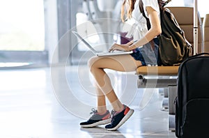 Woman teenager using laptop computer at airport
