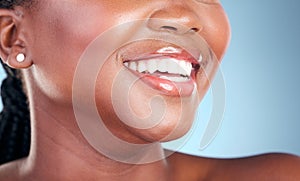 Woman, teeth and smile in dental cleaning, hygiene or treatment against a blue studio background. Closeup of female