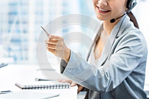 Woman telemarketing staff pointing hand while working in office