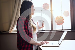 Woman teleworker works at home with a laptop. she is in smart working because outside is full of covid 19 coronavirus photo