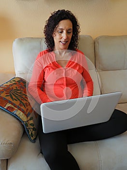 Woman teleworking comfortably on her sofa