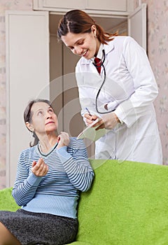 Woman tells the doctor the symptoms of malaise photo