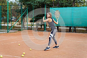 Woman tennis player is focused in a ready position. Athlete waiting for serve on a panoramic green background banner. Challenge