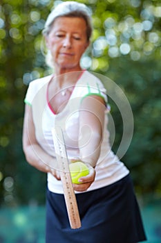 Woman, tennis racket and ball for exercise outdoor for sport workout, game play or match. Mature, female person and