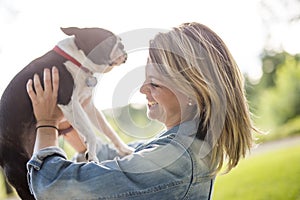 Woman with terrier dog outside at the park