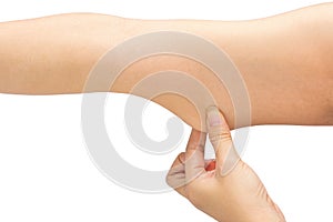 Woman testing the flabby muscle under her arm pulling it down