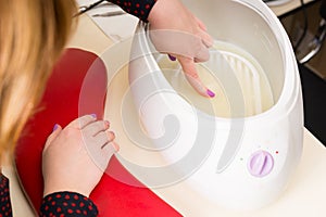 Woman Testing Warmth of Manicure Parrafin Wax