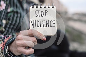 Woman and the text stop violence in a paper