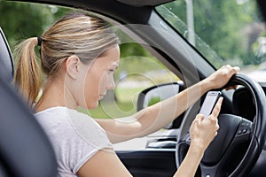 woman texting while driving car