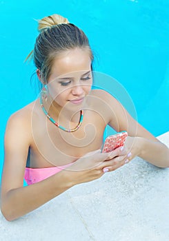 Woman texting in the pool