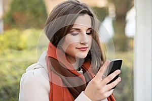 Woman texting, reading sms outdoors.