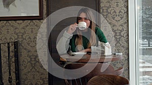 Woman texting, sending sms on smartphone in cafe