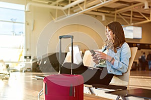 Woman texting and using laptop before getting on the plane