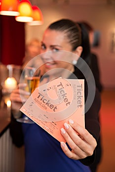 Woman in theatre presenting tickets