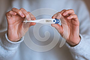 Woman with thermometer closeup