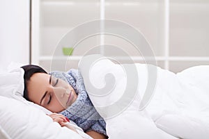 Woman with thermometer sick colds, flu, fever, headache in bed