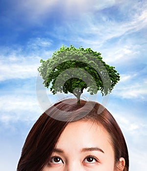 Woman thinking idea growth tree on her's head.