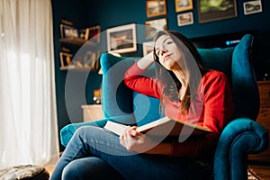 Woman thinking/imagining about a romance love story book novel she is reading,home alone in quarantine.Romantic woman imagination.