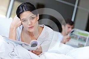 Woman, thinking and portrait with magazine and boyfriend for contemplate future with article for rest in home. Mexican photo