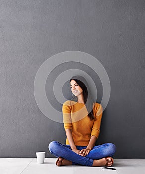 Woman, thinking and relax or calm in home, peace and cup of coffee on floor of living room. Female person, mockup space
