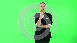 Woman thinks about something, no idea. Green screen