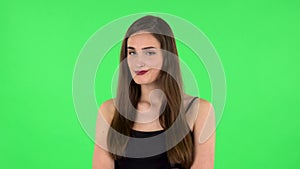 Woman thinks about something, no idea. Green screen